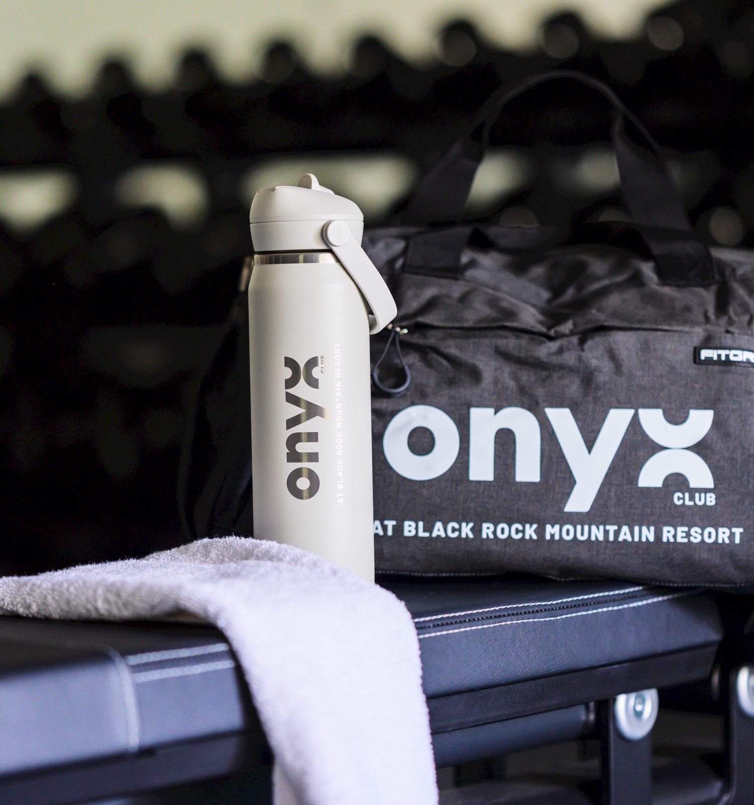 A gym bag, water bottle, and towel placed on a black workout bench at Black Rock Mountain Resort.