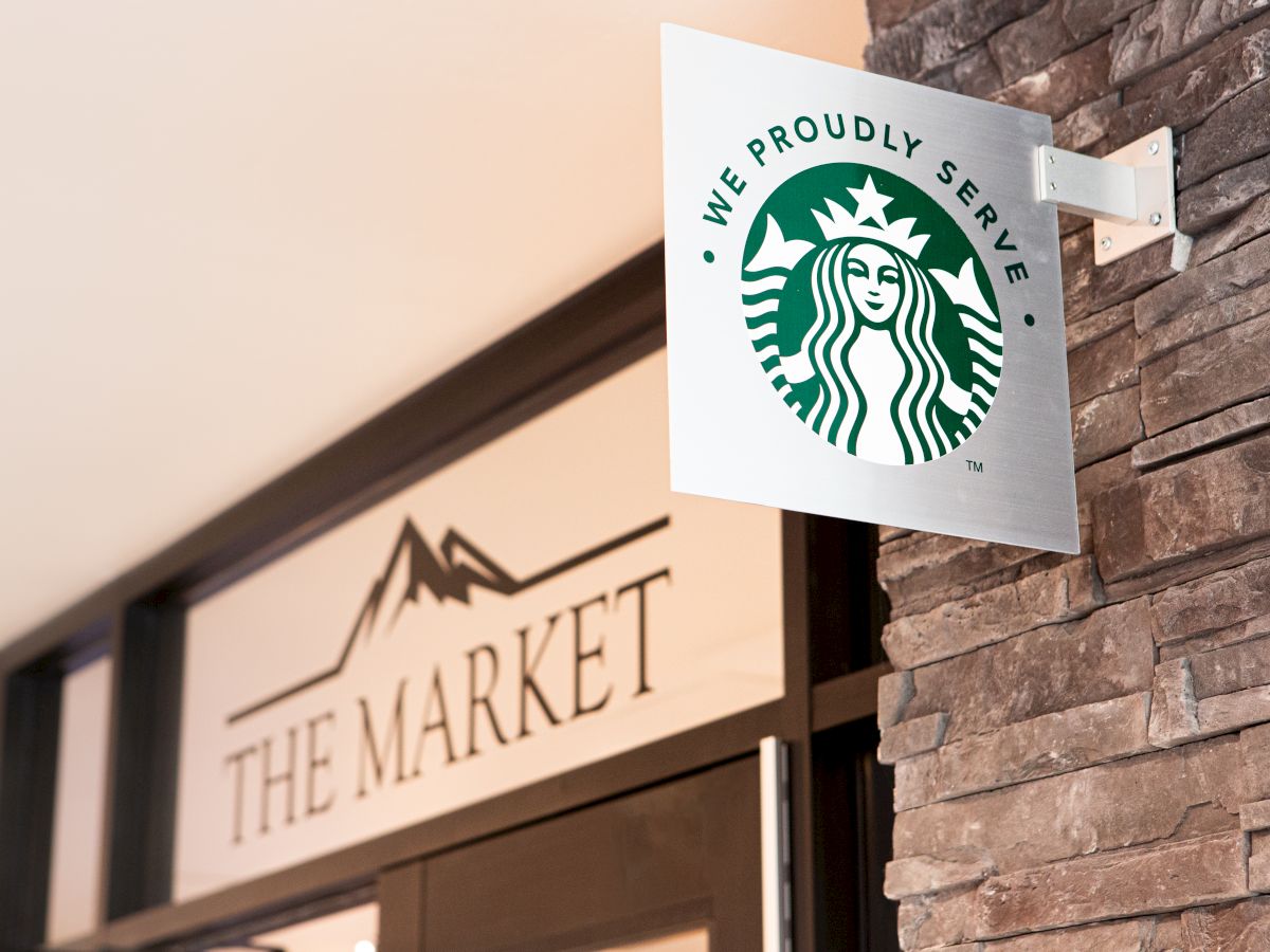 The image shows a sign with the Starbucks logo and text 