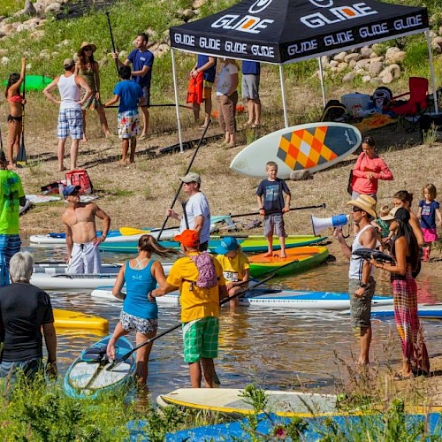 people getting into the water to paddleboard on a warm summer day