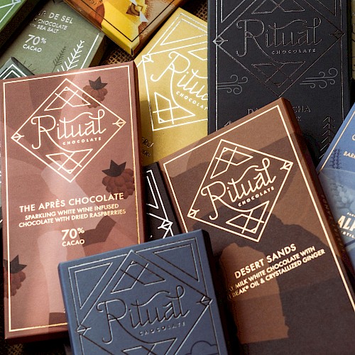 The image shows various colorful chocolate packaging from Ritual Chocolate, featuring diverse flavors and cacao percentages.