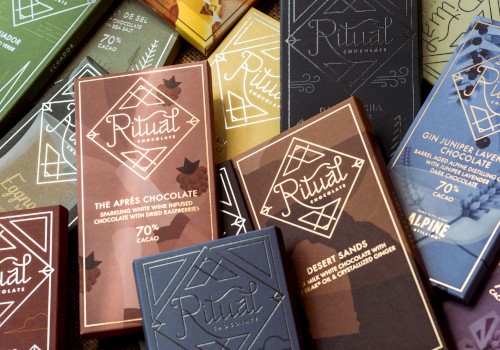 A variety of Ritual Chocolate bars with different flavors and cacao percentages are displayed in colorful packaging.